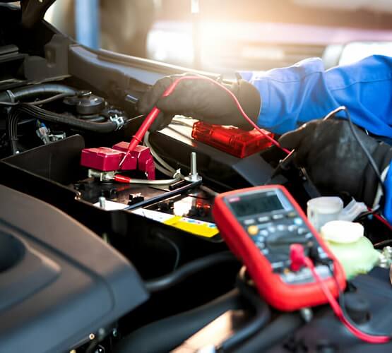 Technician Checking Battery Voltage